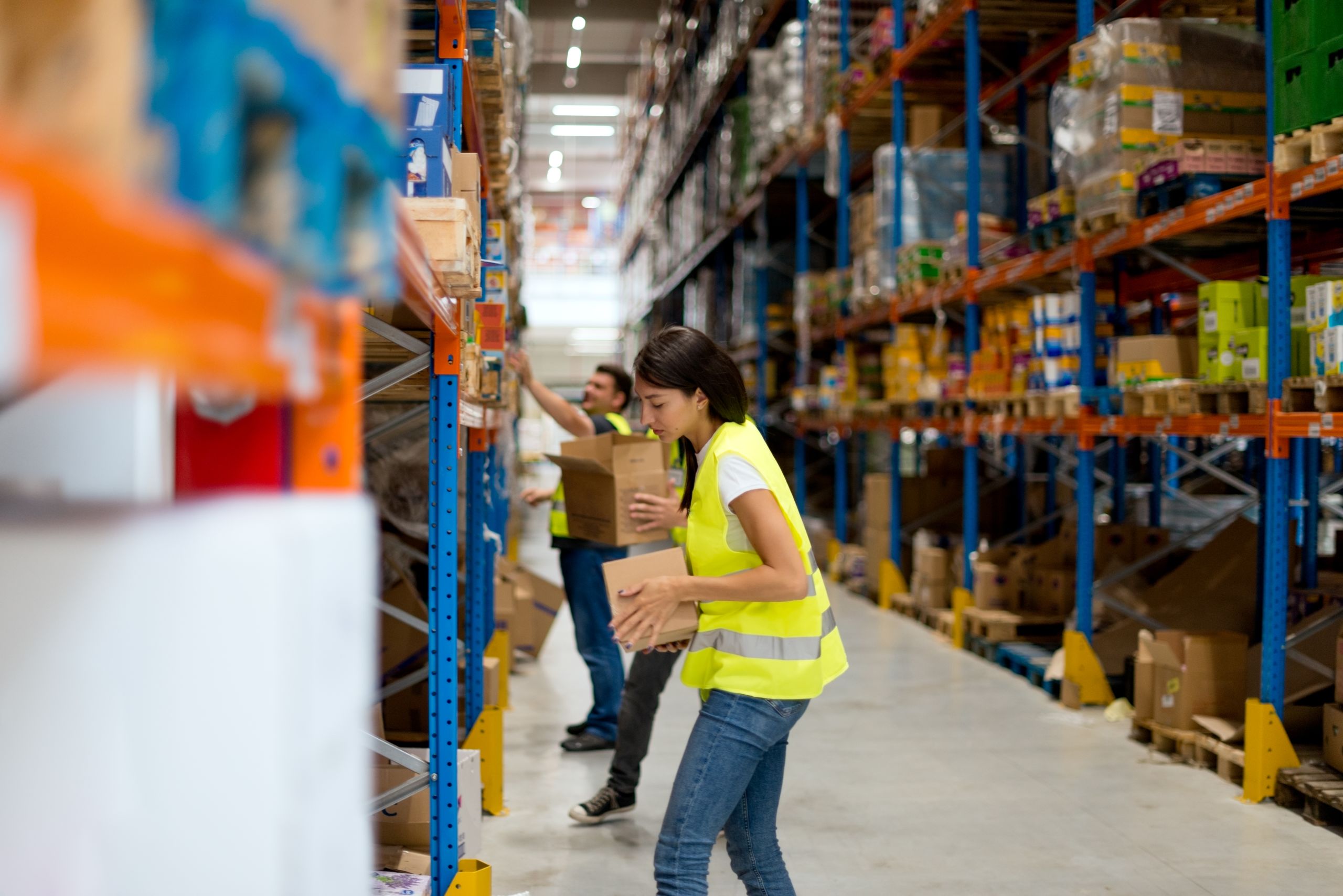 Person stocking a warehouse full of boxes