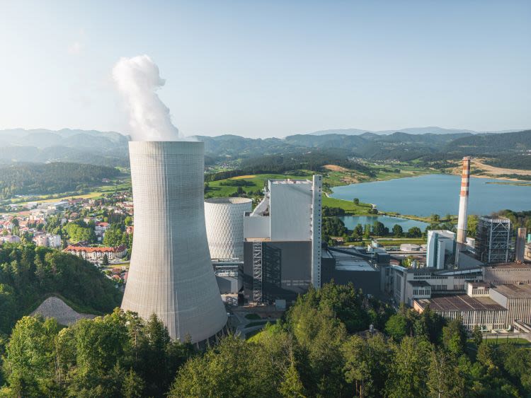 Big coal power station with active cooling tower emitting gases into environment