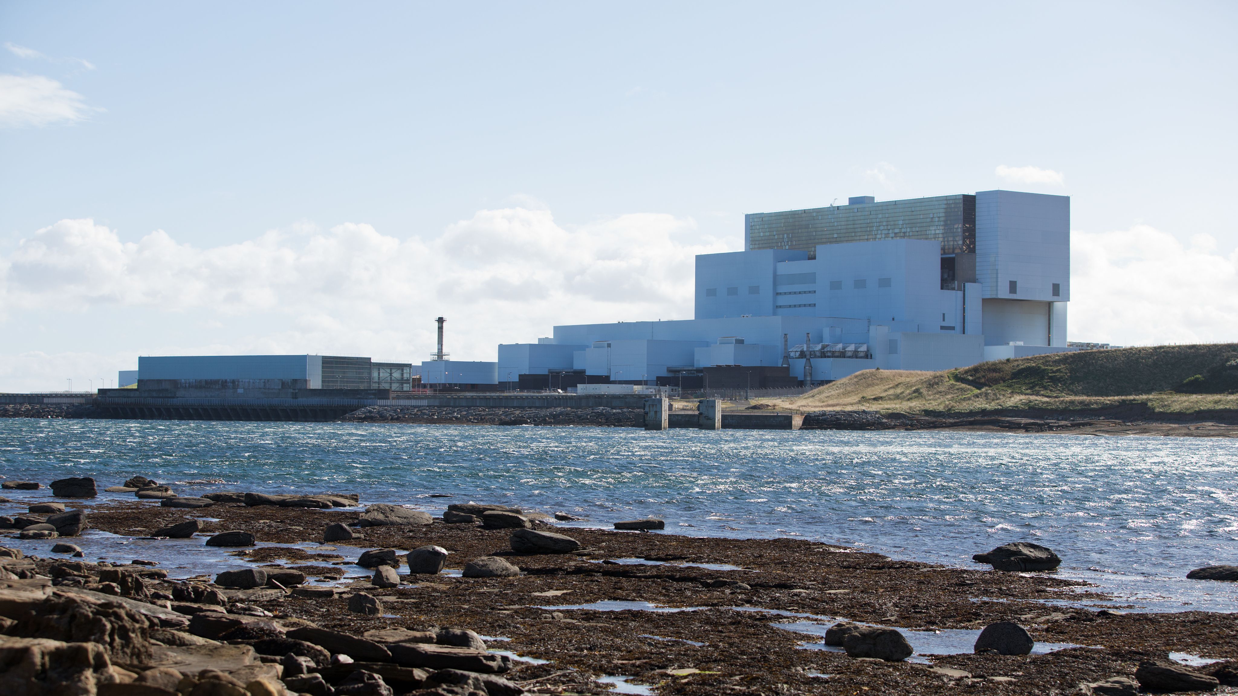 photography of nuclear plant by the water