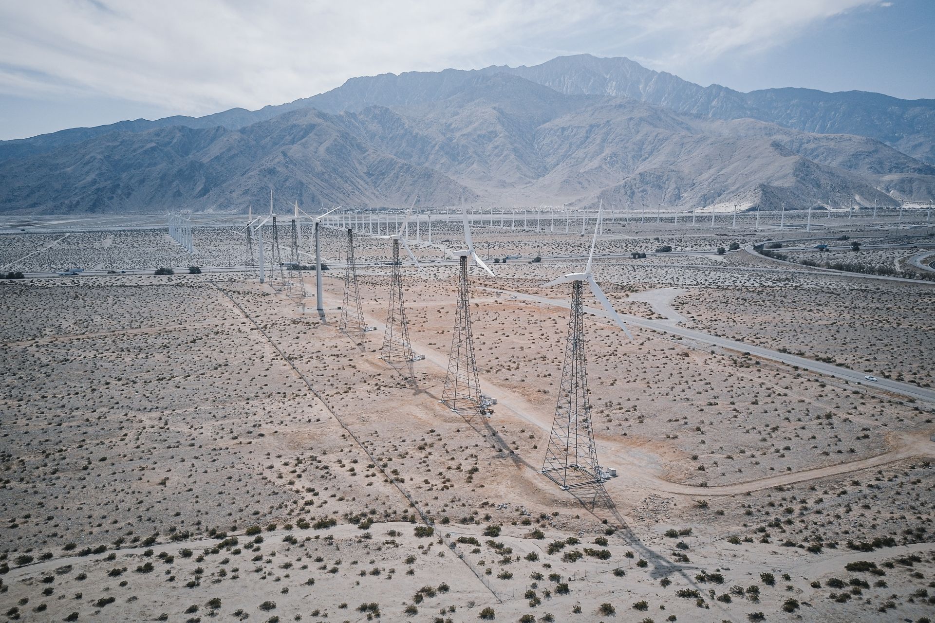 photography of multiple Wind Turbines Near Mountains