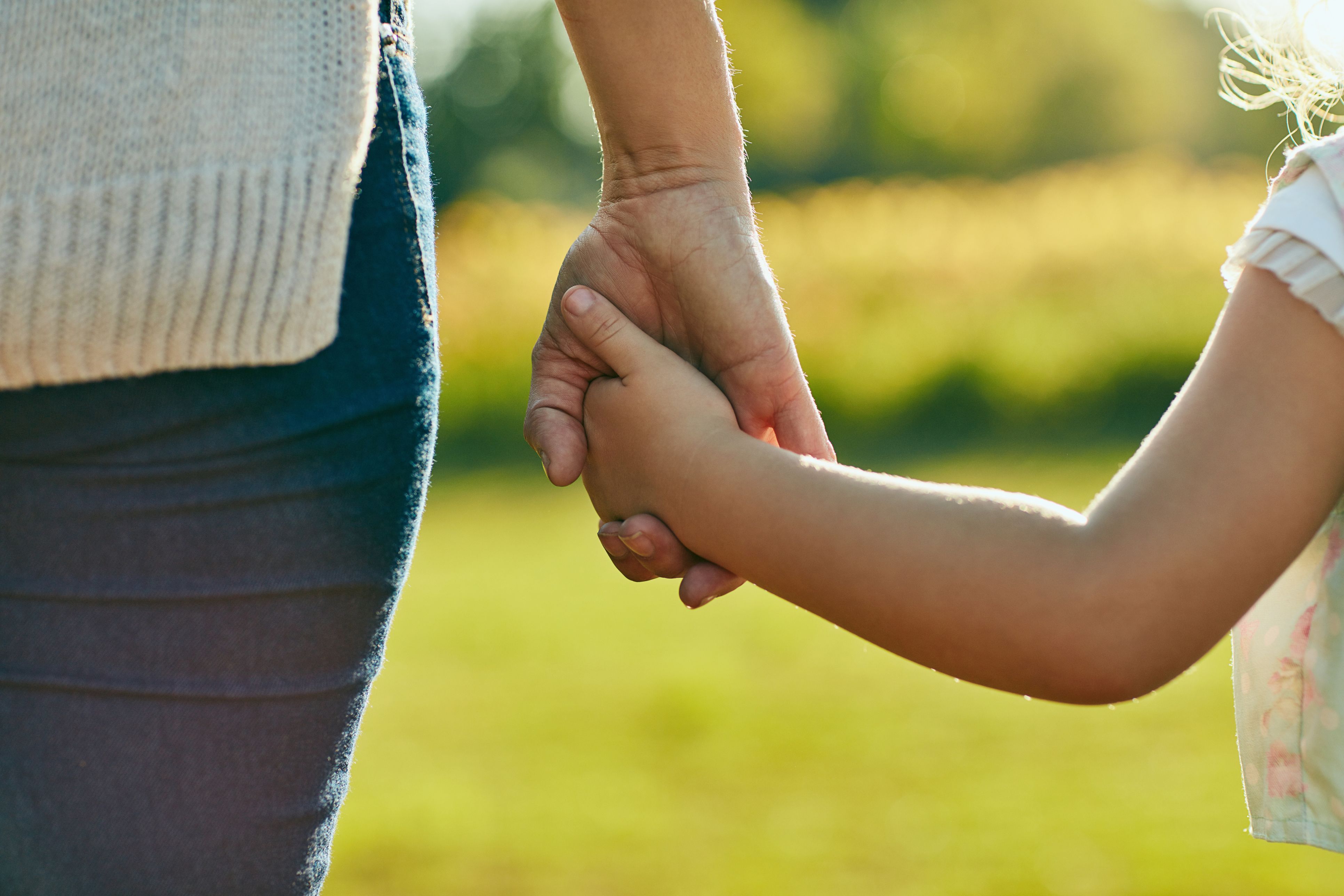 Child and parent holding hands