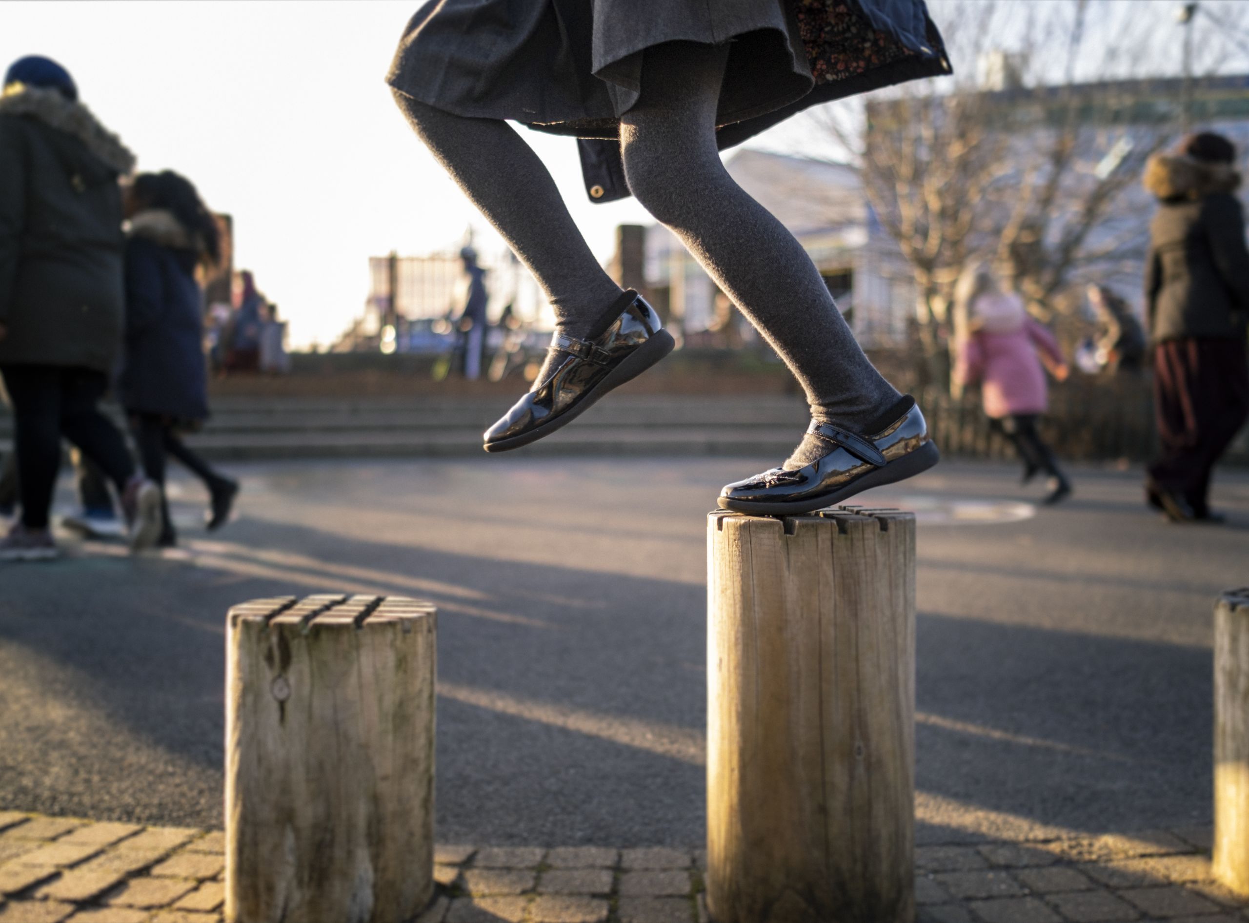 Child skipping on a climbing frame at school