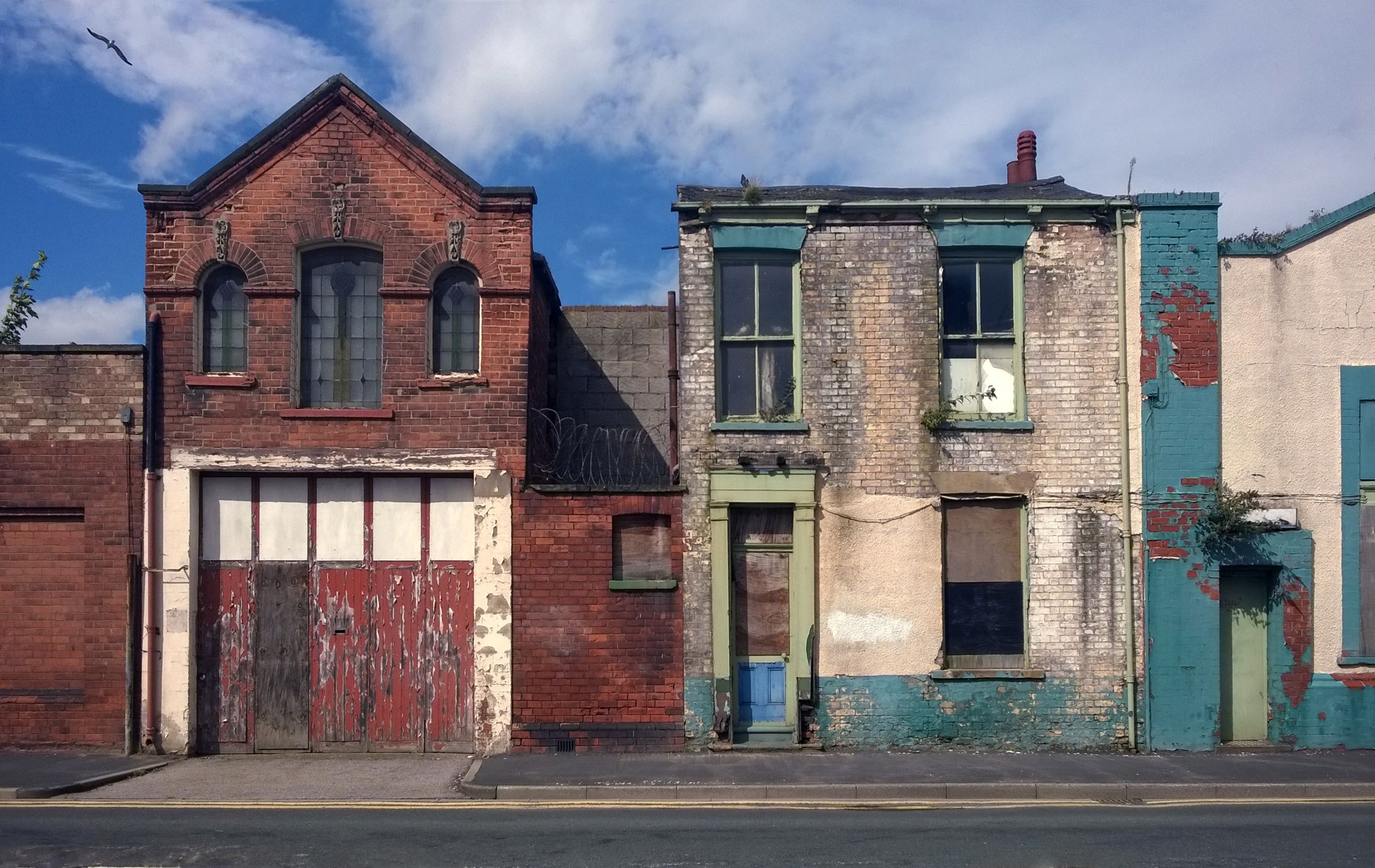 Derelict warehouse with broken and boarded windows