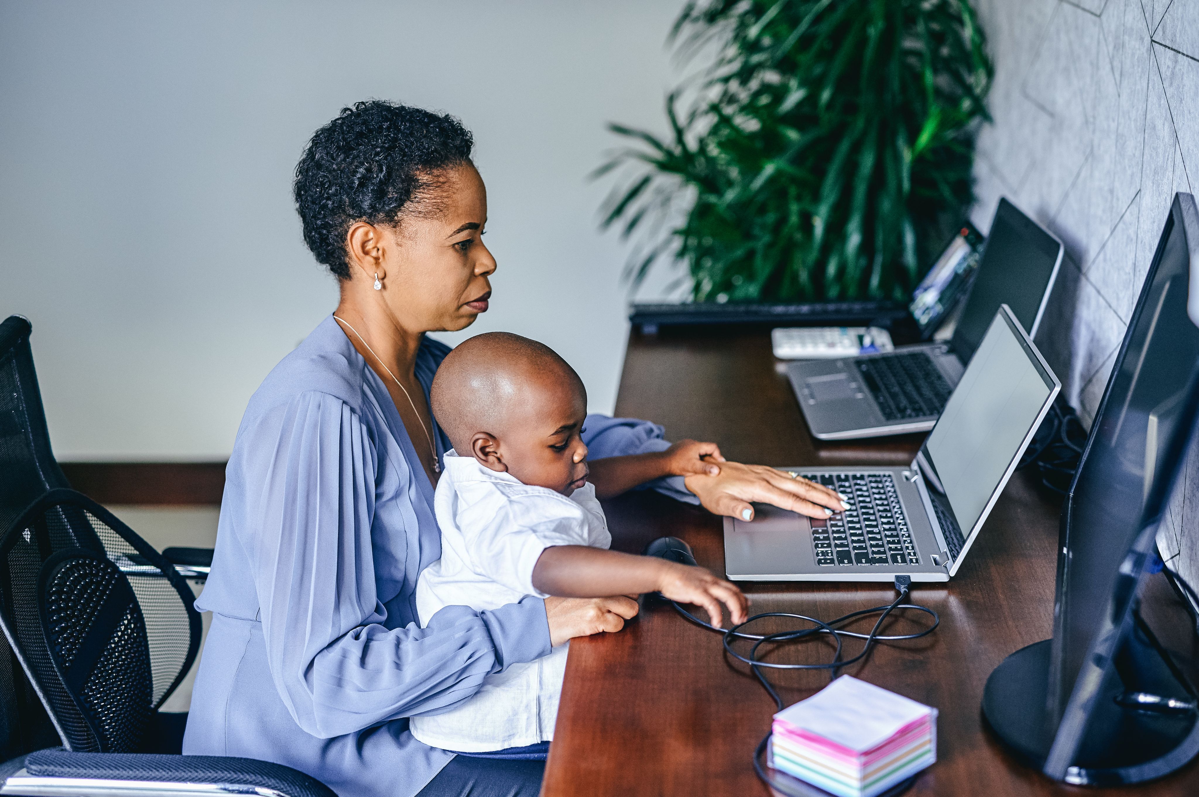 Woman and a child sat in front of a laptop