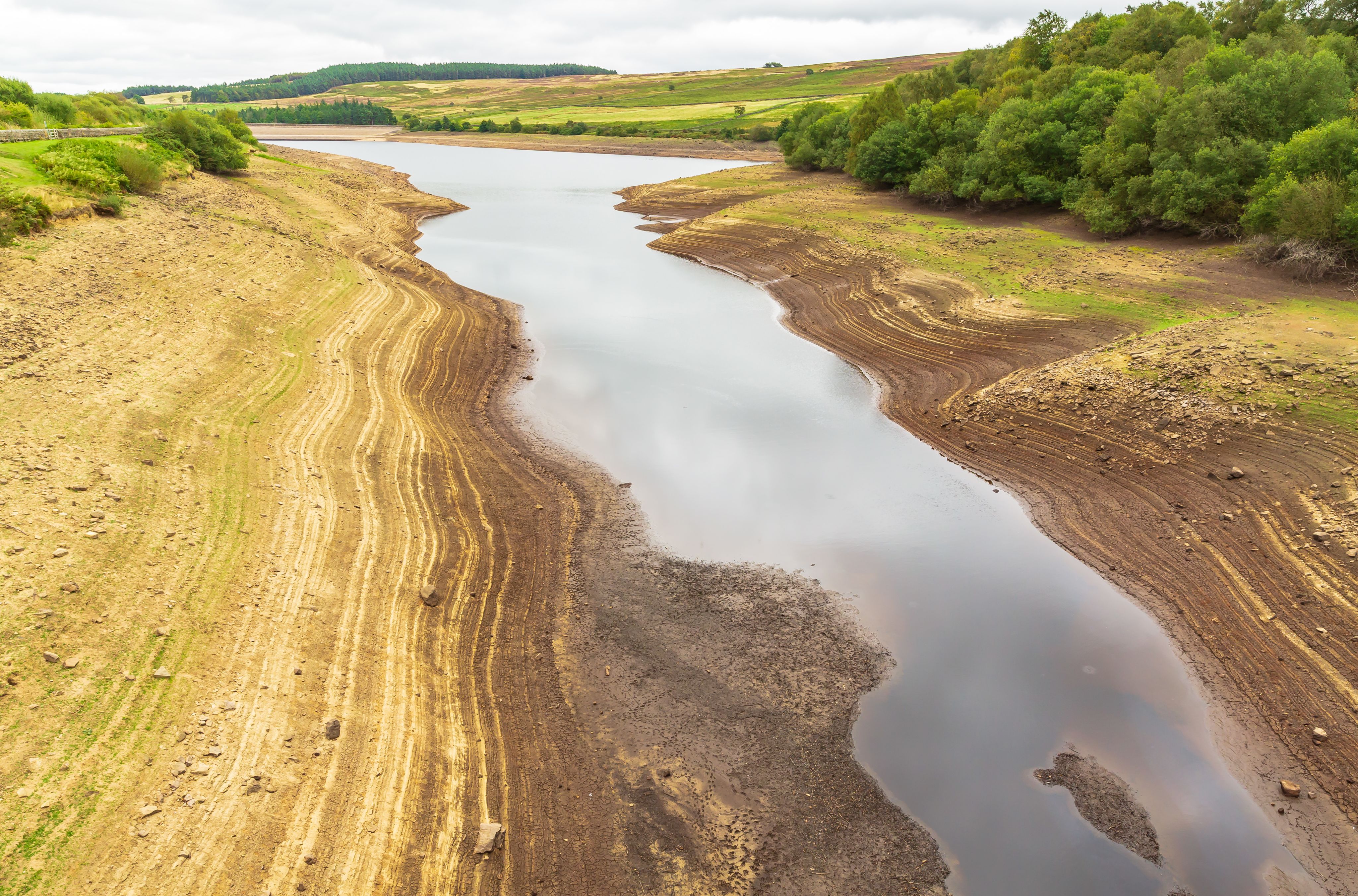 Leighton Reservoir in Nidderdale, North Yorkshire, UK, with very low water levels following a prolonged heatwave and no rainfall. Horizontal.
