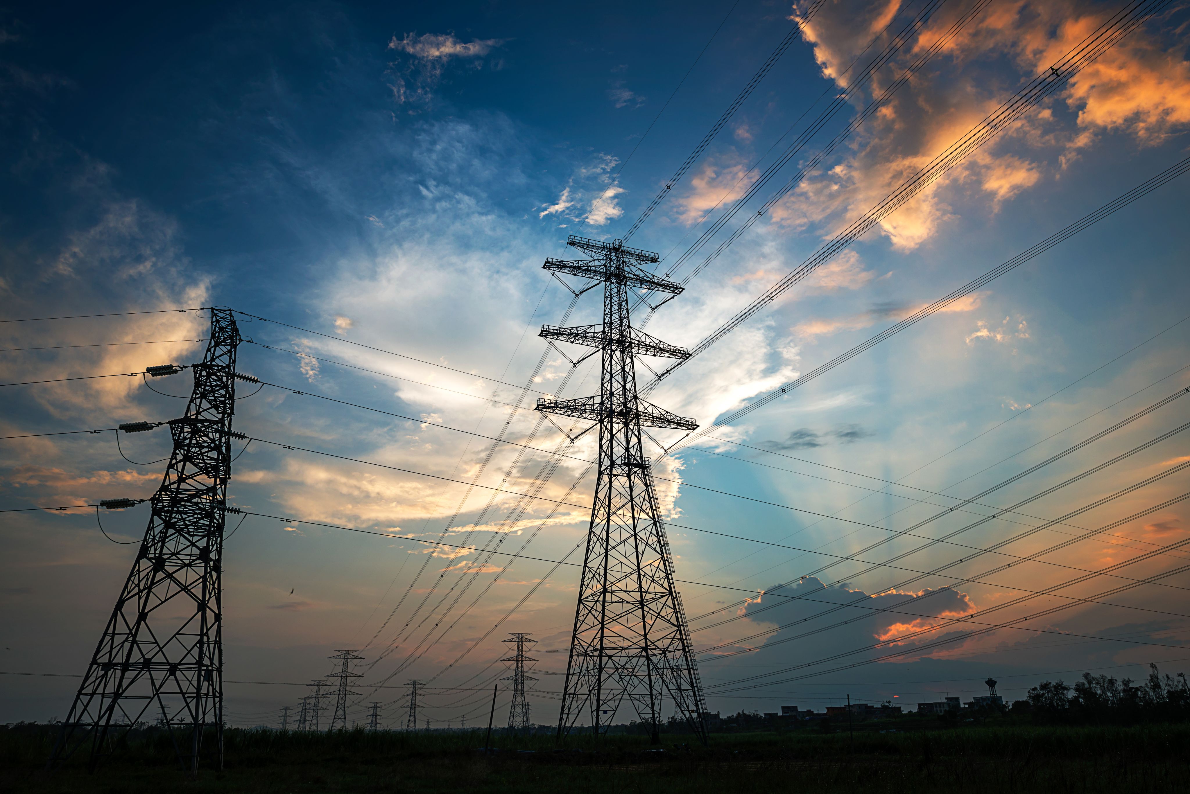 Electricity Pylon power line transmission tower at sunset.