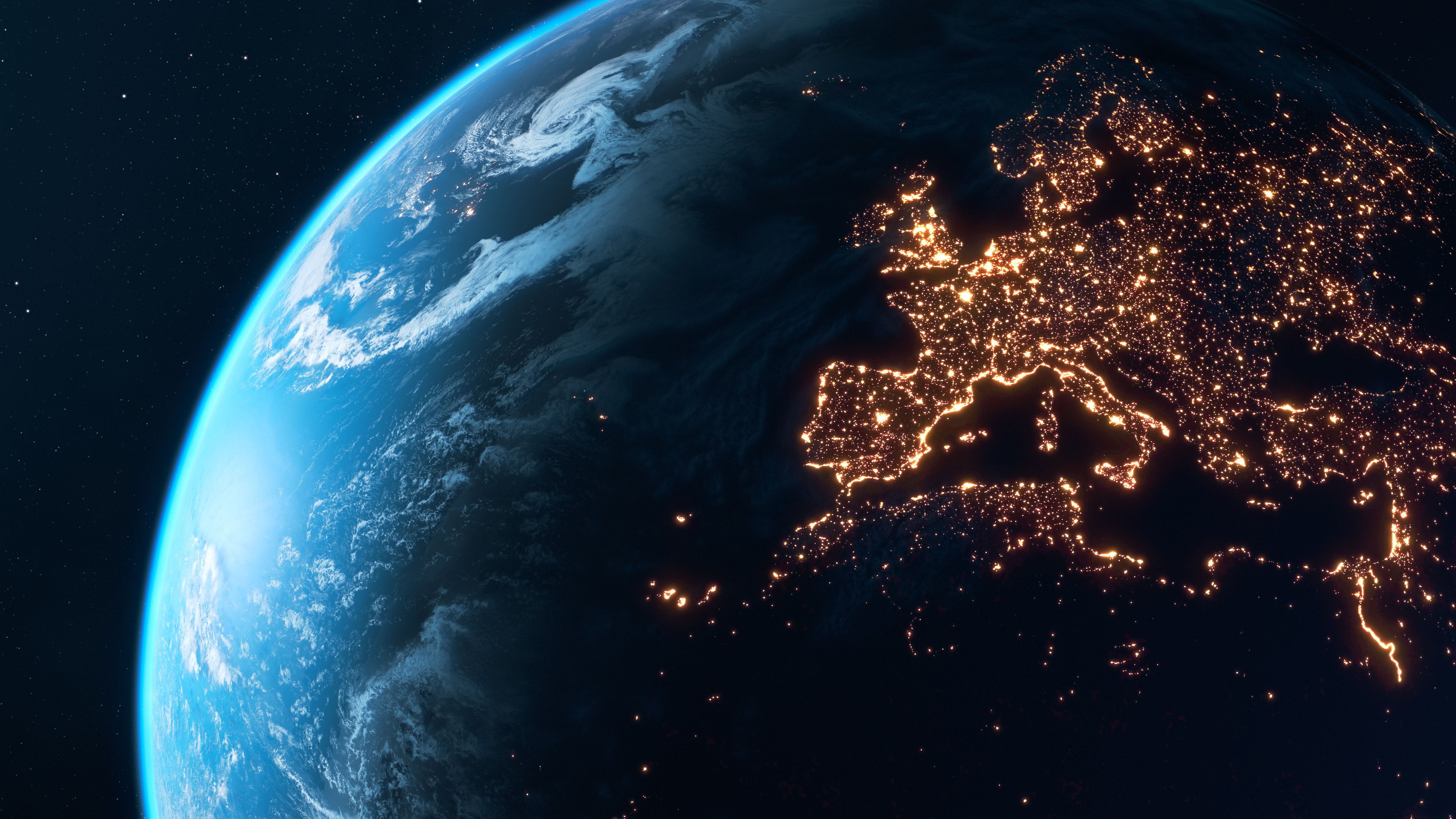 planet earth at night showing city lights of Europe glowing in the dark