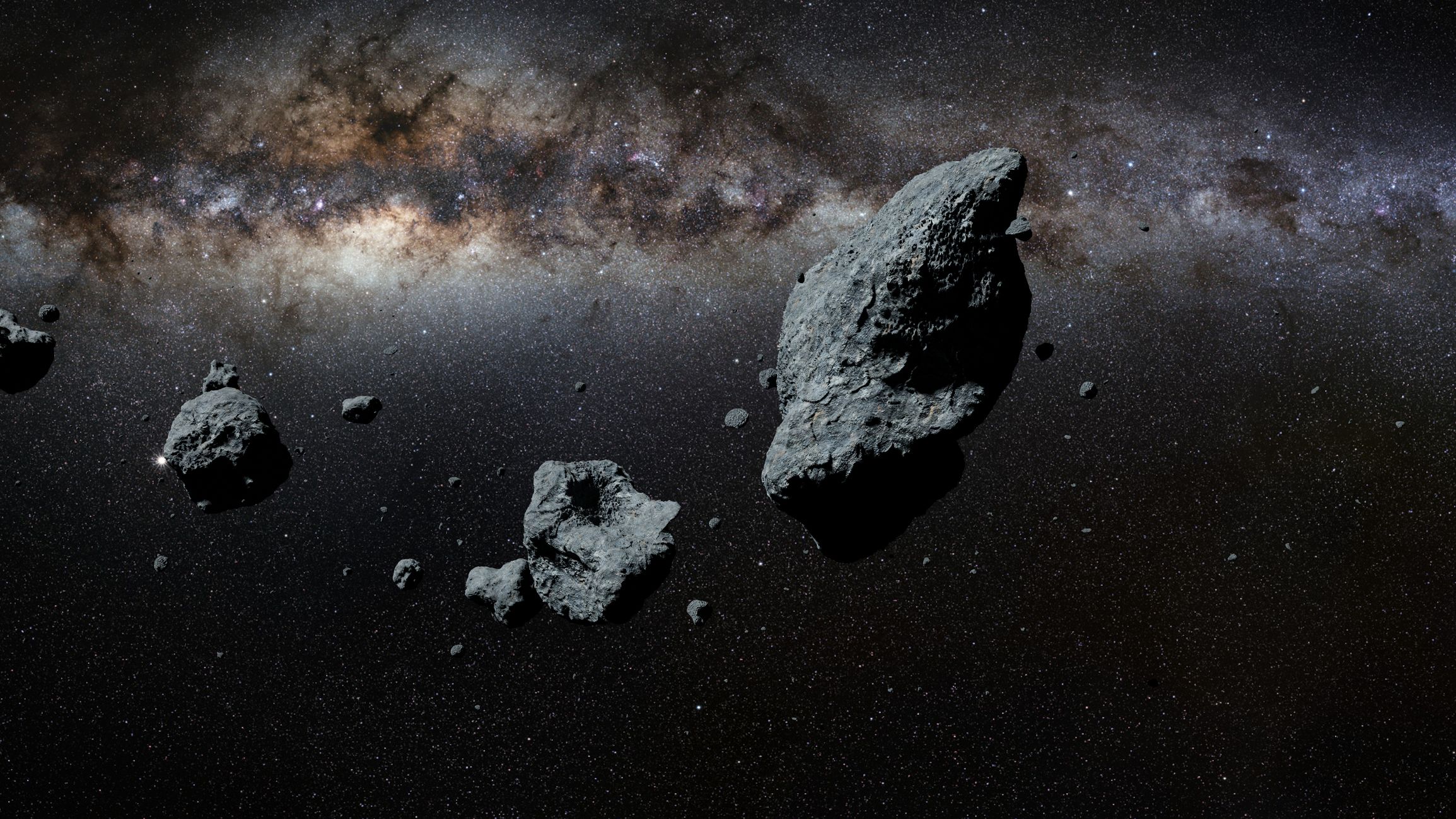 Asteroids floating thorough space, Milky Way is in the background.