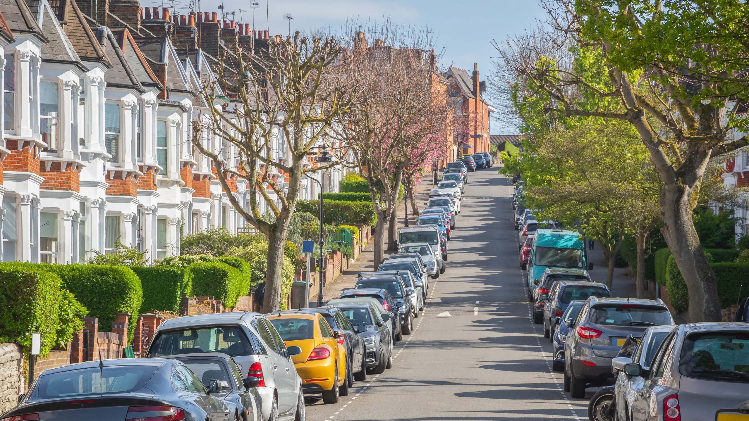 Picture of empty London housing street with cars parked in a line during Lockdown 