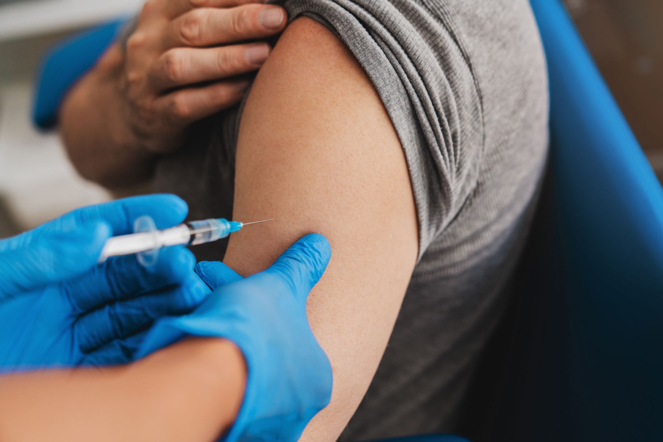 A patient receives a vaccine in their arm