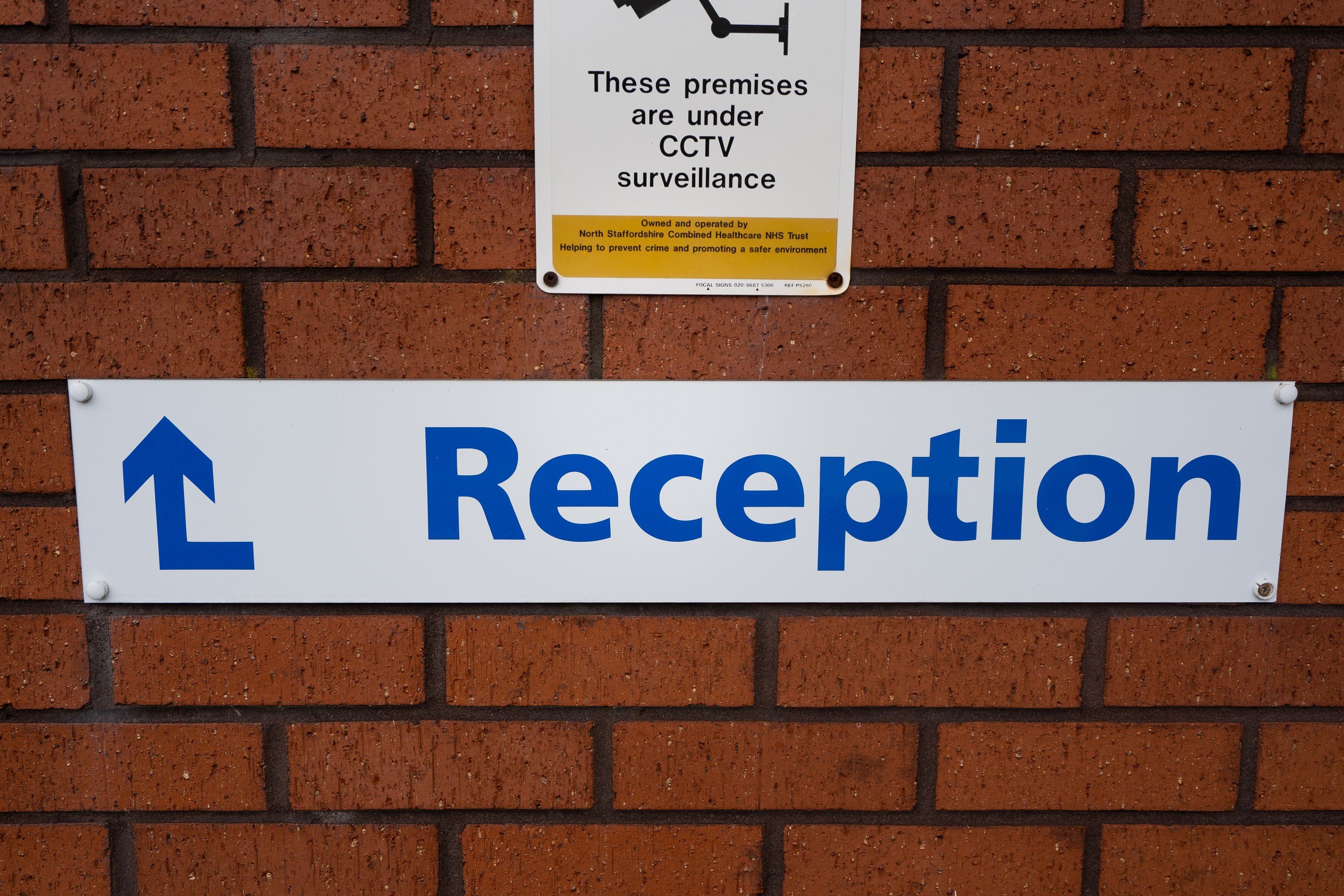 A reception sign for an NHS service